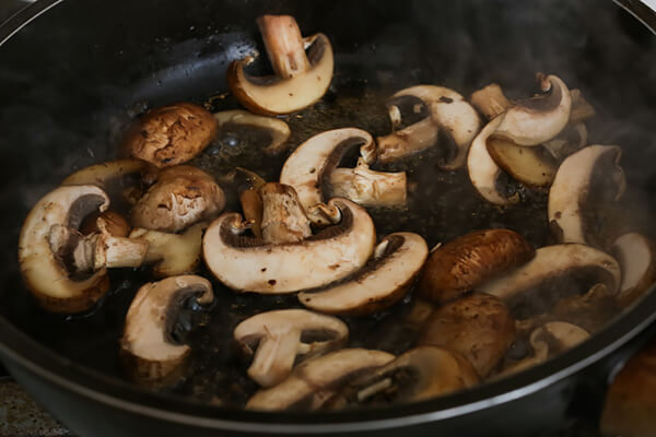 Cooking mushroom slices in the pan.