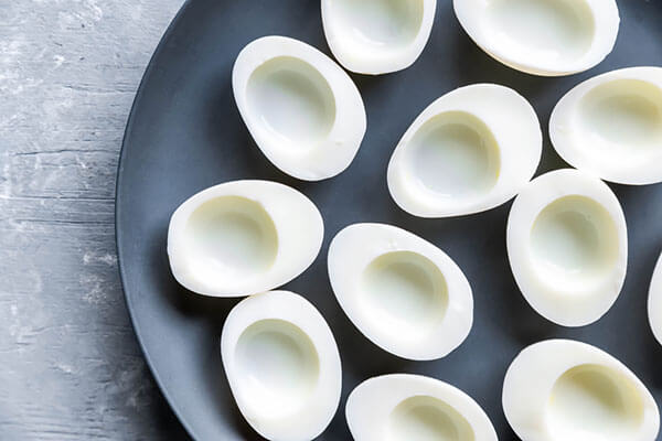Empty hard boiled eggs on a plate.