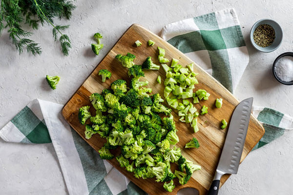 Chopping the broccoli.